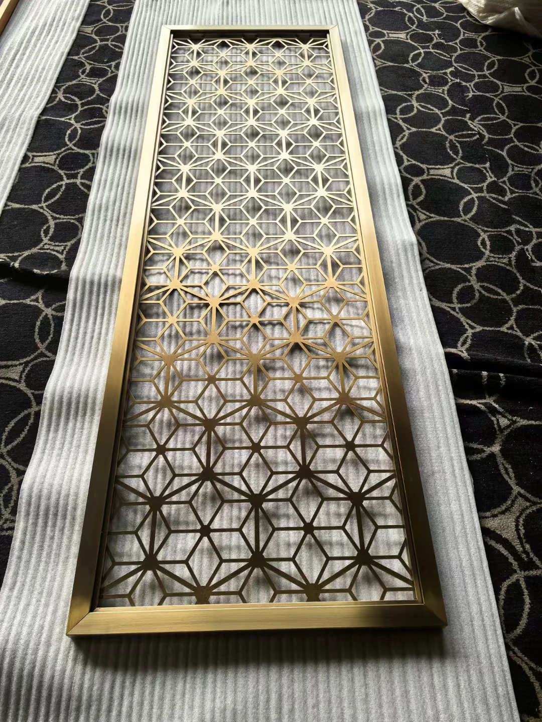 Laser-cut stainless steel screen with a custom decorative pattern 3