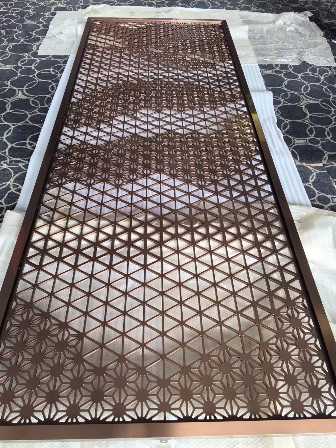Laser-cut stainless steel screen with a custom decorative pattern 4