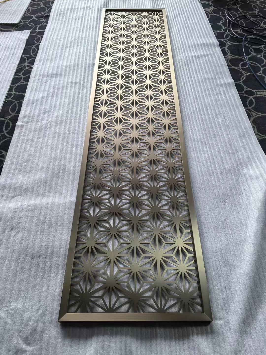 Laser-cut stainless steel screen with a custom decorative pattern 6